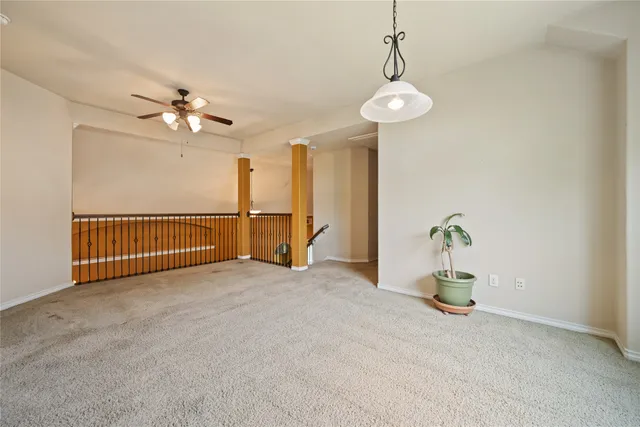 a view of a room with a ceiling fan