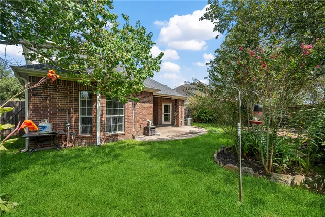 a front view of a house with garden and a garden