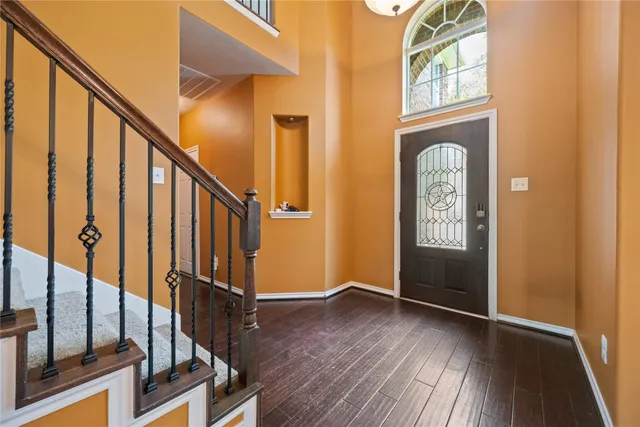 a view of an entryway with wooden floor and door