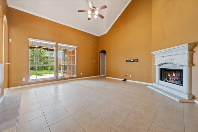 a view of an empty room with a fireplace and a window