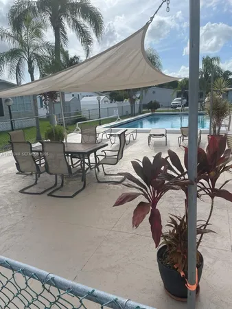 a view of a patio with table and chairs