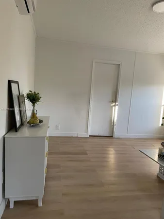 a view of kitchen with furniture and wooden floor