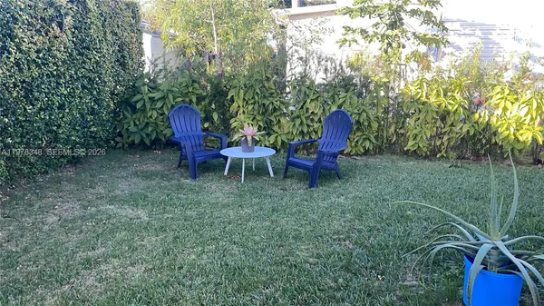 a view of a chairs in backyard of the house
