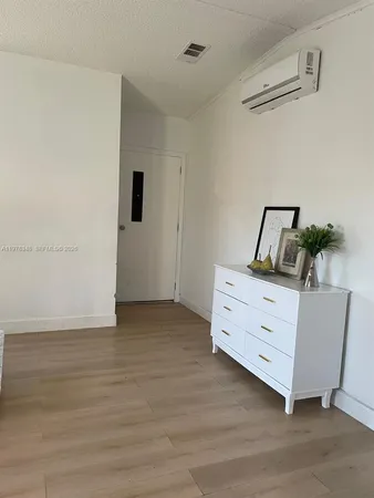 a room with furniture and wooden floor