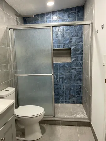 a bathroom with a toilet and a shower