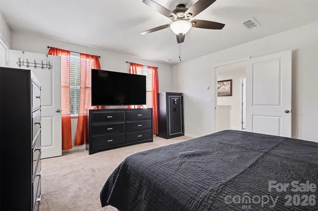 a bedroom with a bed and dresser with mirror