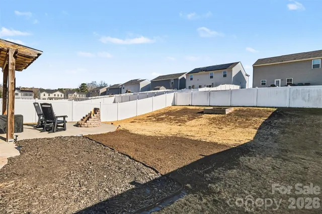 a backyard of a house with table and chairs