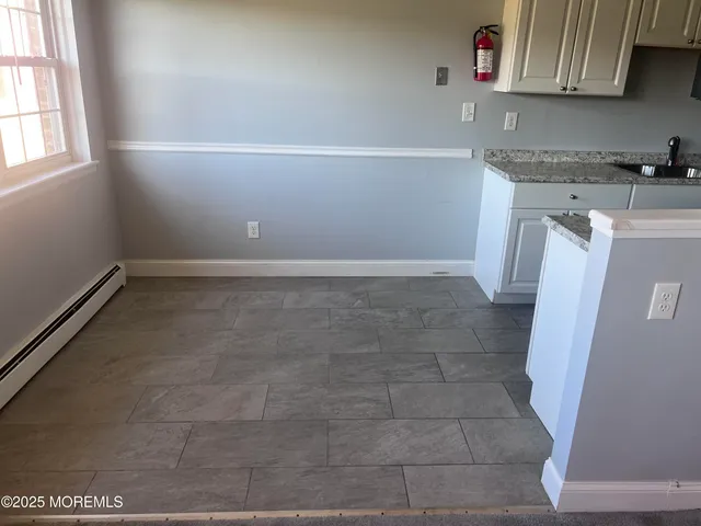 a kitchen with a sink a stove and cabinets