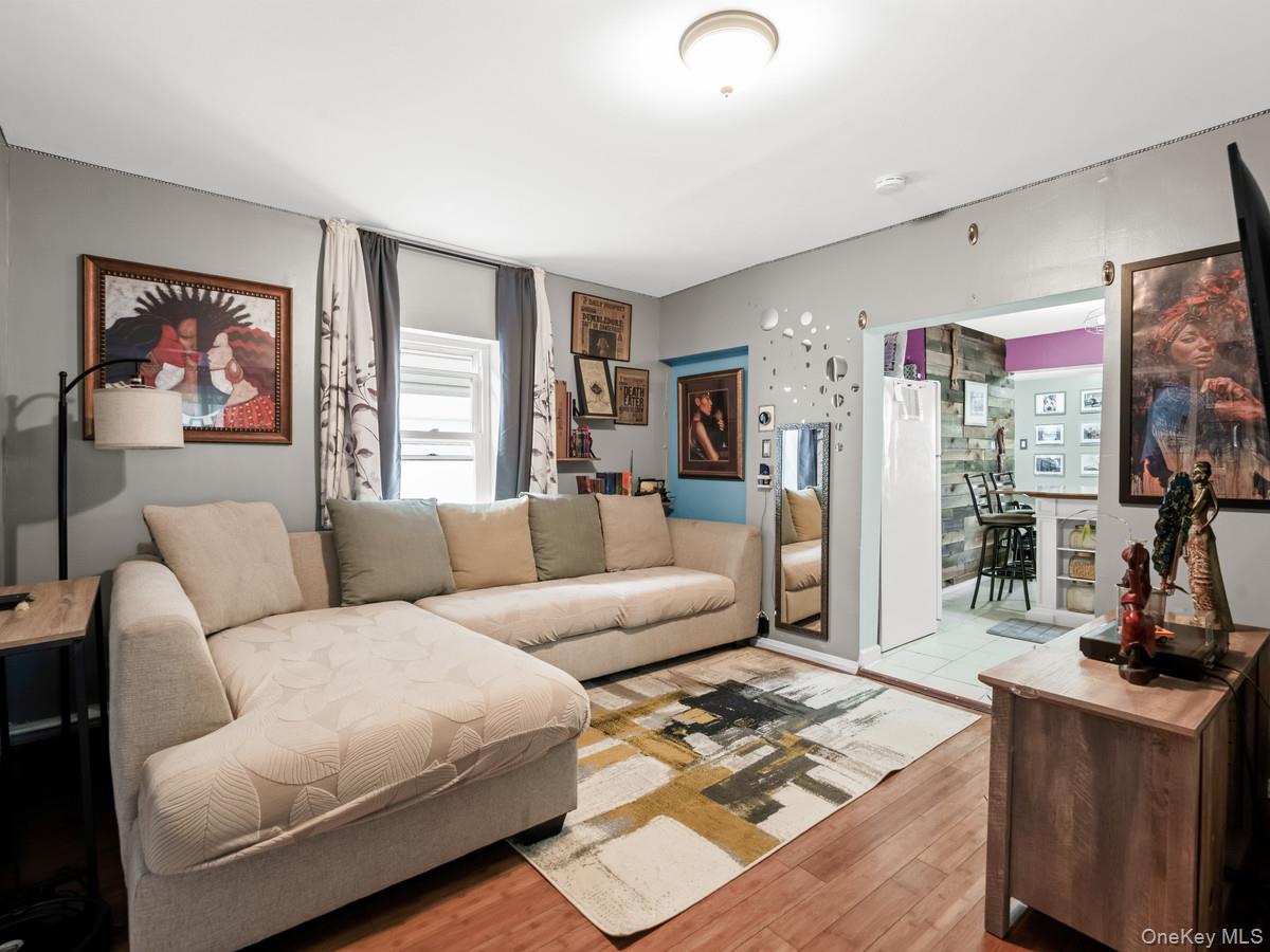 218-12 141st Road Queens, NY 11413 - Photo 3 of 14 a living room with furniture and a flat screen tv
