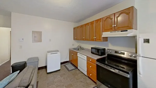 a kitchen with wooden cabinets and stainless steel appliances