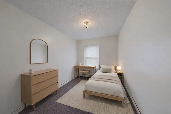 a bedroom with a bed and a dresser