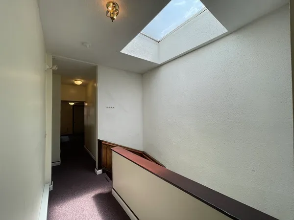 a view of hallway with bathroom