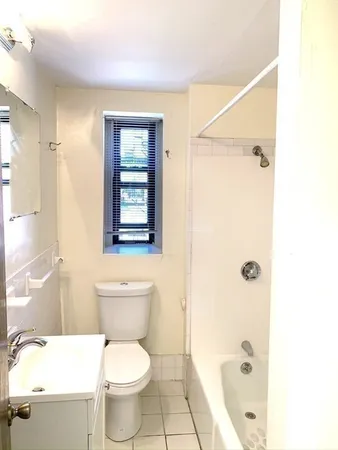 a bathroom with a toilet a sink and shower