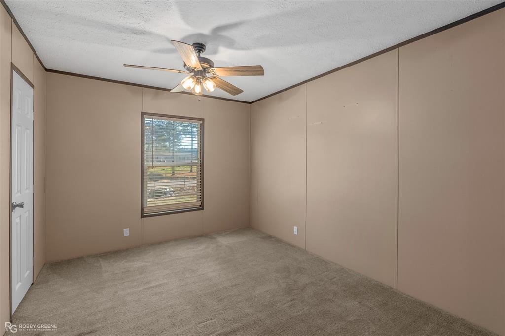 295 Cass Pvt Drive Gloster, LA 71030 - Photo 17 of 28 an empty room with windows and fan