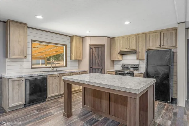 a kitchen with a stove a refrigerator and a sink