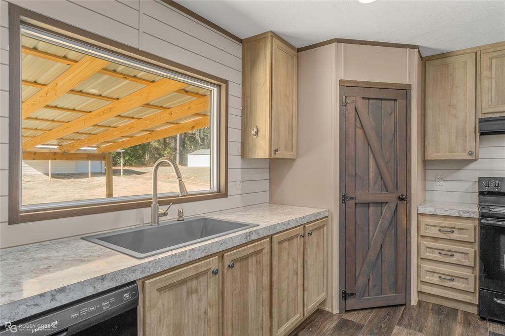 295 Cass Pvt Drive Gloster, LA 71030 - Photo 5 of 28 a kitchen with granite countertop a sink and a window