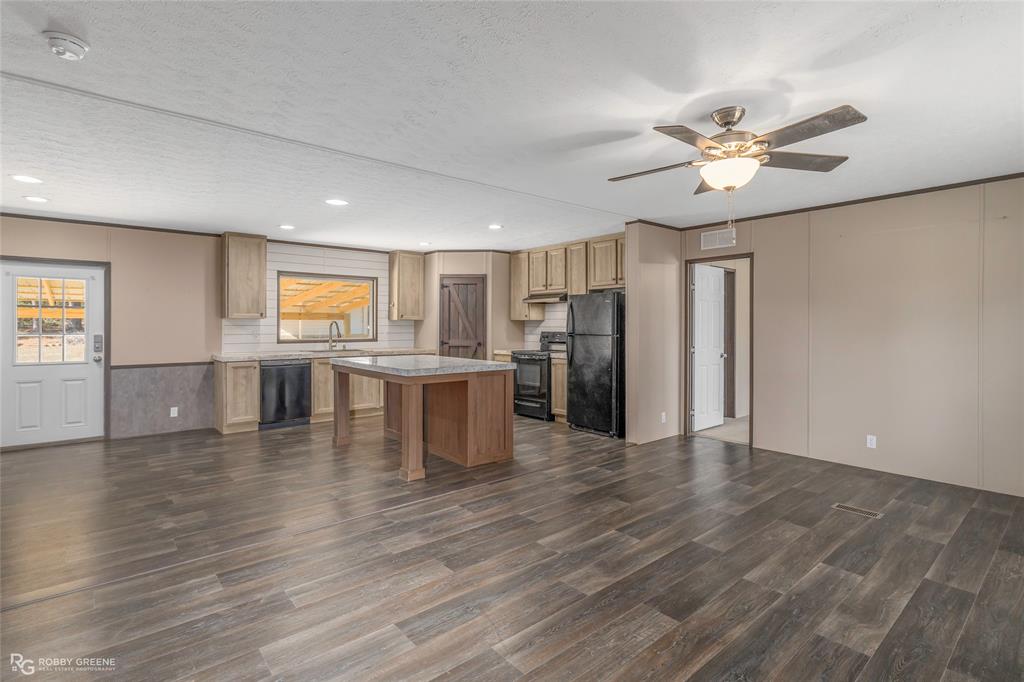 295 Cass Pvt Drive Gloster, LA 71030 - Photo 7 of 28 a view of an empty room with window and wooden floor