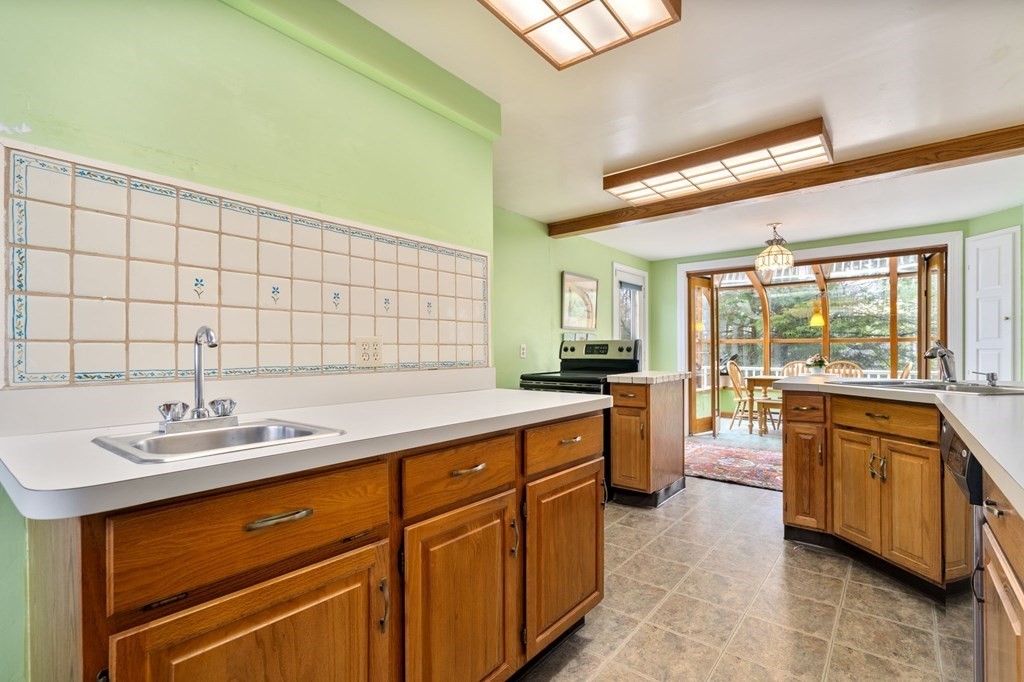 135 Tower Avenue Needham, MA 02494 - Photo 12 of 24 a large kitchen with stainless steel appliances granite countertop a sink and cabinets