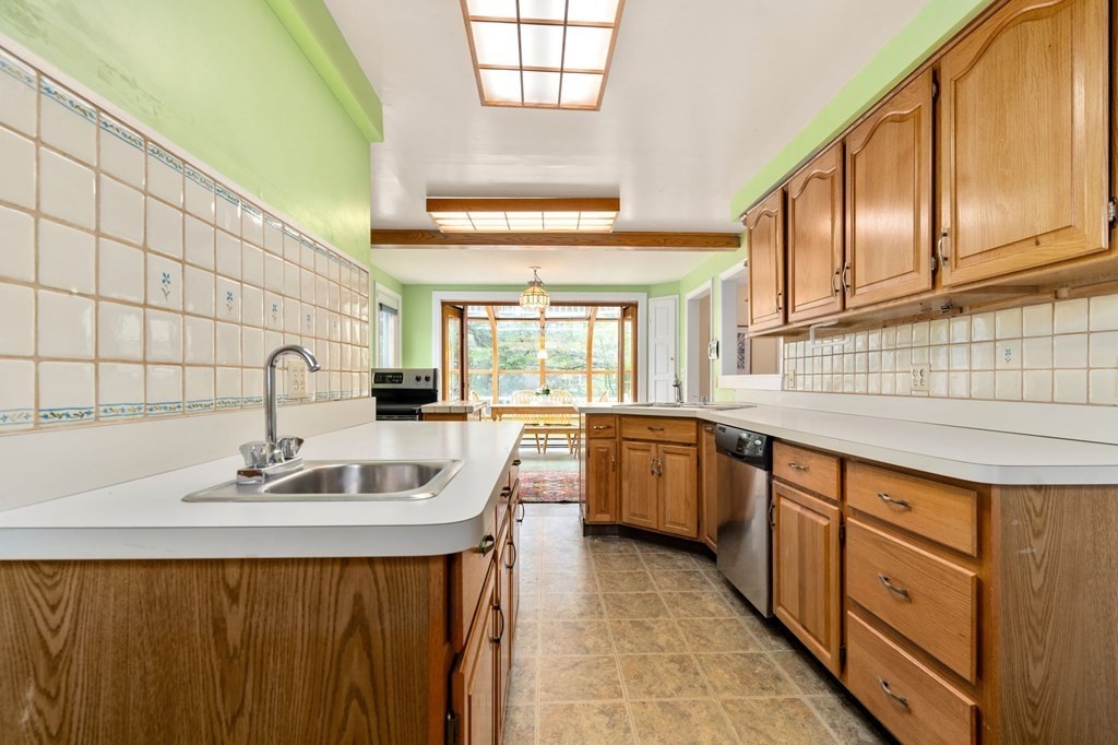 135 Tower Avenue Needham, MA 02494 - Photo 13 of 24 a kitchen with stainless steel appliances granite countertop a sink and cabinets