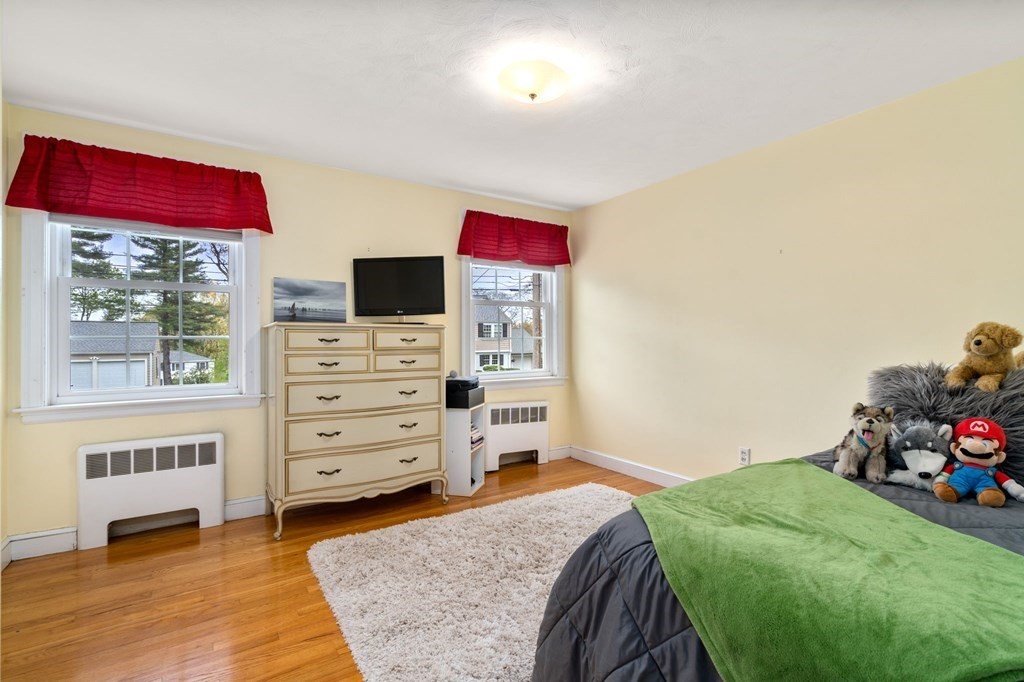 135 Tower Avenue Needham, MA 02494 - Photo 18 of 24 a bedroom with a bed and a tv