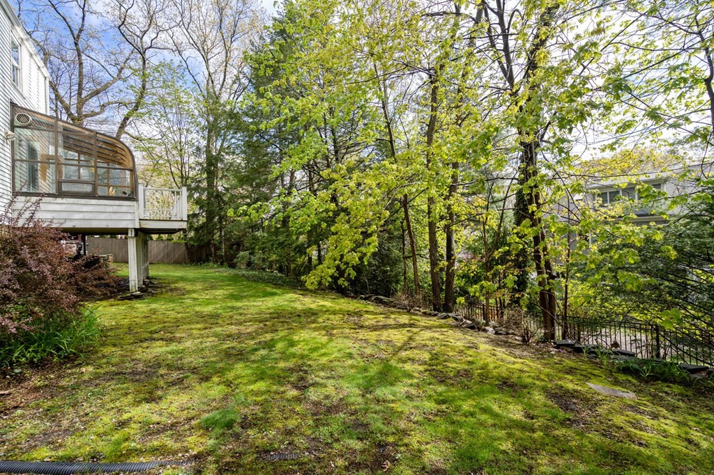 135 Tower Avenue Needham, MA 02494 - Photo 22 of 24 a backyard of a house with table and chairs
