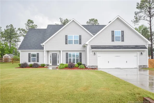 a front view of house with yard and green space