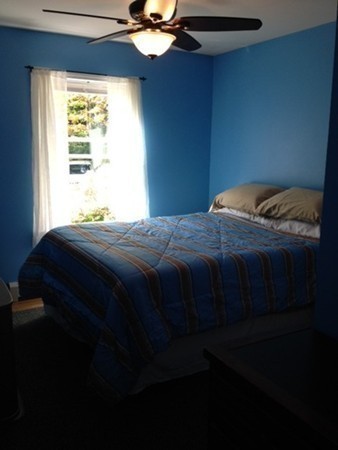 270 Main Road Chesterfield, MA 01012 - Photo 20 of 30 a bedroom with a bed that has a blanket and a window
