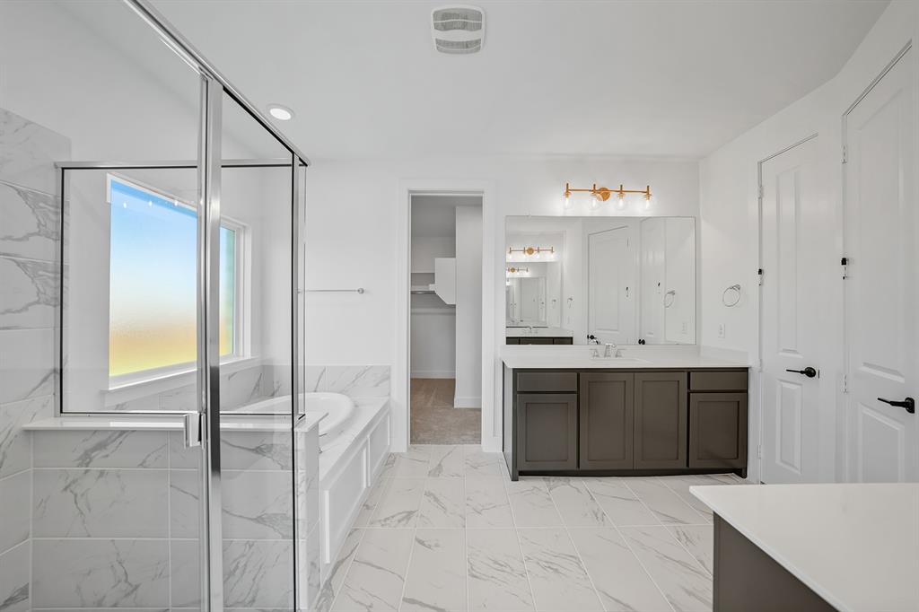 587 Mayfair Lane Frisco, TX 75033 - Photo 22 of 37 a spacious bathroom with a bathtub and a shower