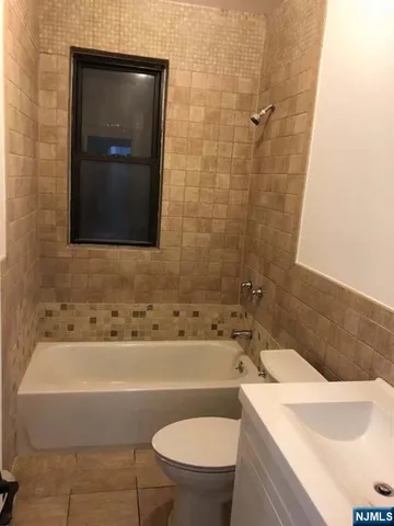 a bathroom with a sink a toilet and bathtub