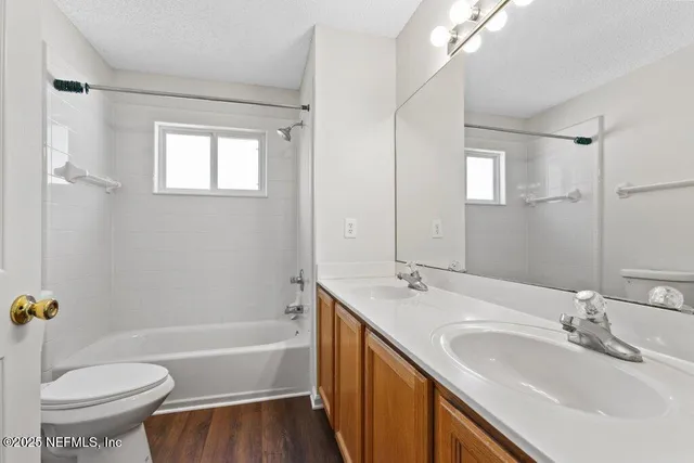 a bathroom with a tub sink toilet and a mirror