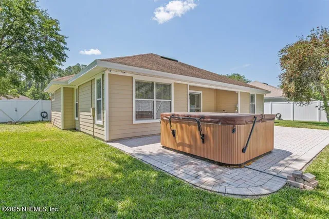 a view of a house with a backyard and a patio