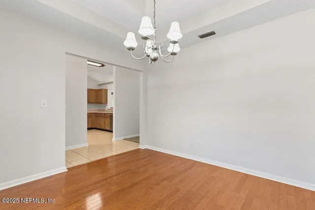 a view of an empty room with a kitchen