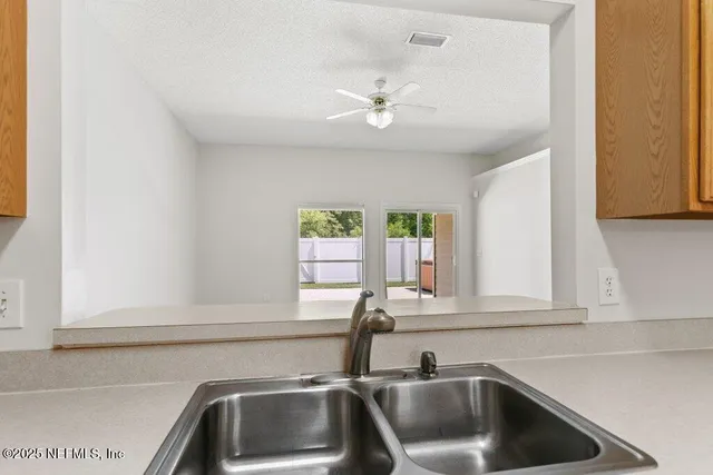 a kitchen with a sink and cabinets