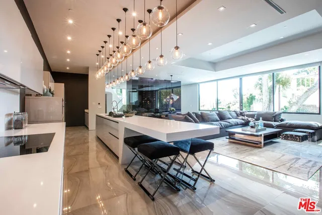 a living room with fireplace furniture and a large window