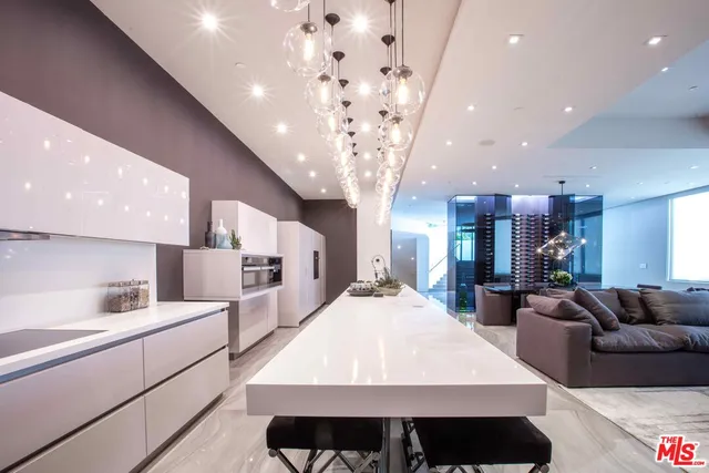 a large room with kitchen island a large island in it