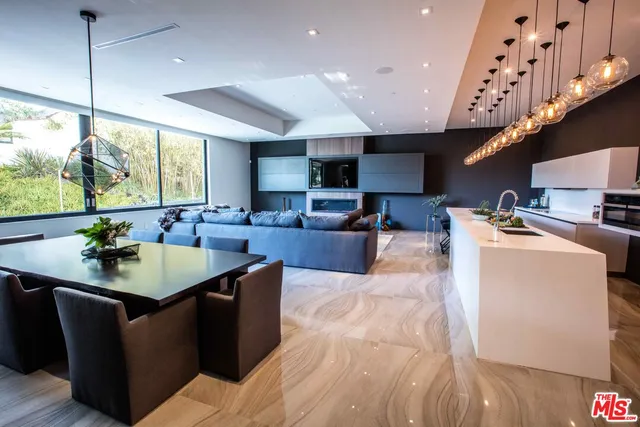 a kitchen with kitchen island granite countertop a sink counter top space and a couch