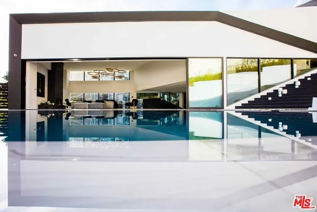 a kitchen with sink refrigerator and stove top oven