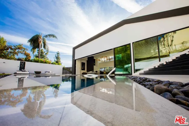 a view of a chairs and table in the balcony