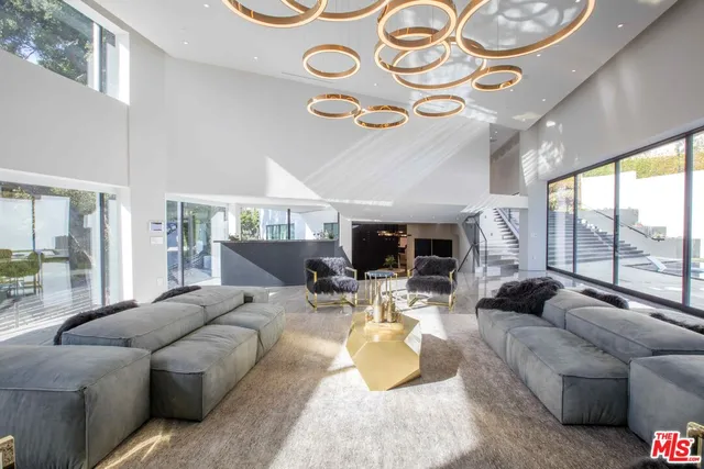 a living room with furniture a large window and a fireplace