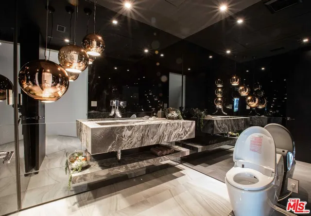 a living room with patio furniture and a potted plant