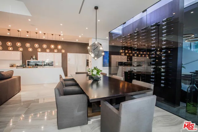 a dining room with kitchen island a table and chairs