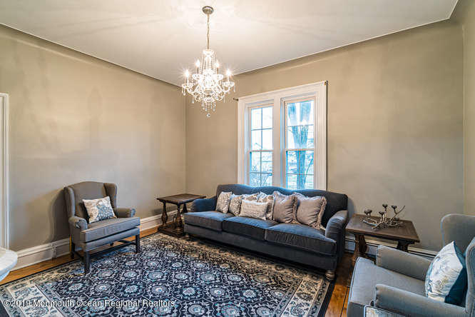 801 Adelphia Road Freehold, NJ 07728 - Photo 25 of 43 a living room with furniture and a chandelier