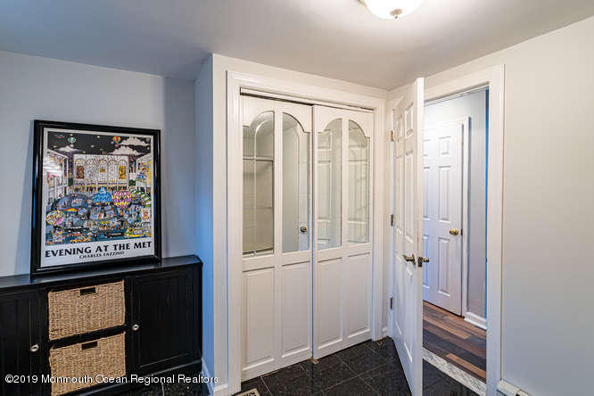 801 Adelphia Road Freehold, NJ 07728 - Photo 27 of 43 a view of a hallway with wooden floor and cabinet