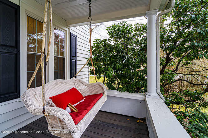 801 Adelphia Road Freehold, NJ 07728 - Photo 29 of 43 a view of balcony with wooden floor and outdoor seating