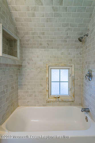801 Adelphia Road Freehold, NJ 07728 - Photo 31 of 43 a bathroom with a bathtub and window
