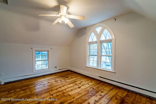 801 Adelphia Road Freehold, NJ 07728 - Photo 39 of 43 an empty room with wooden floor fan and windows
