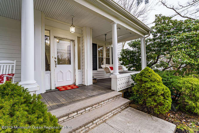 801 Adelphia Road Freehold, NJ 07728 - Photo 6 of 43 a front view of a house with a porch