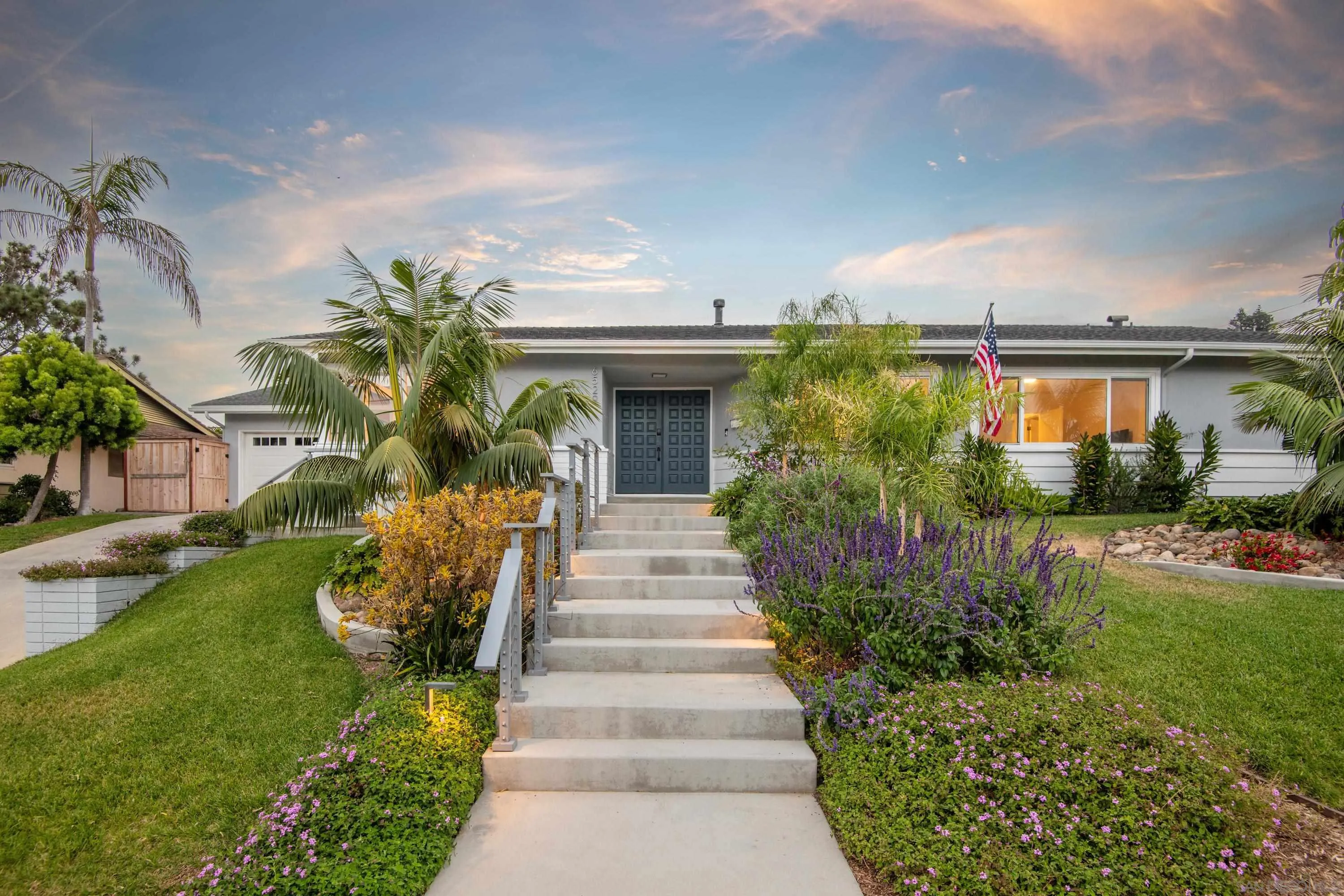 6529 Manana Place La Jolla, CA 92037 - Photo 1 of 36 a front view of a house with a yard and potted plants