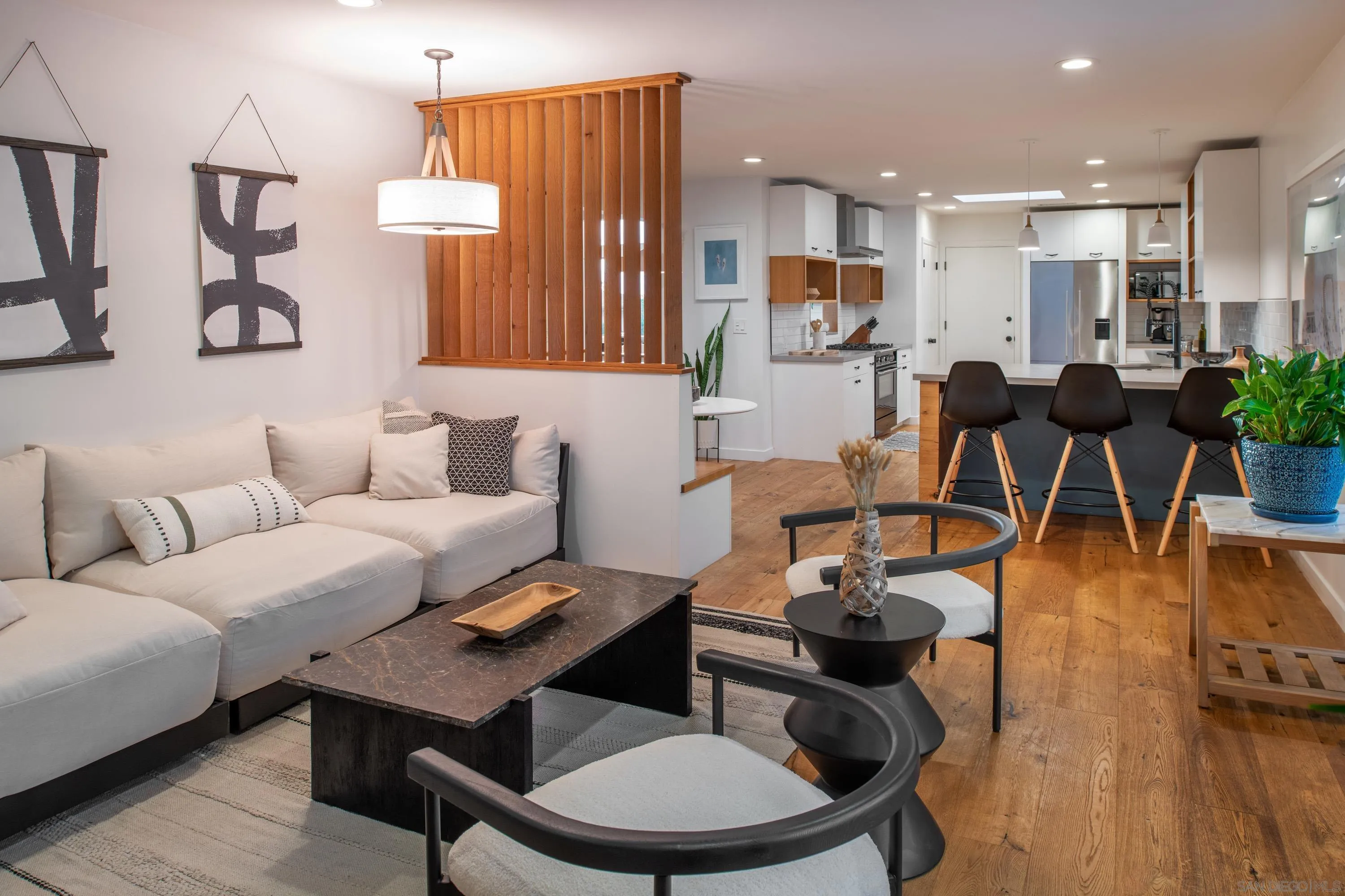 6529 Manana Place La Jolla, CA 92037 - Photo 11 of 36 a living room with furniture kitchen view and a wooden floor