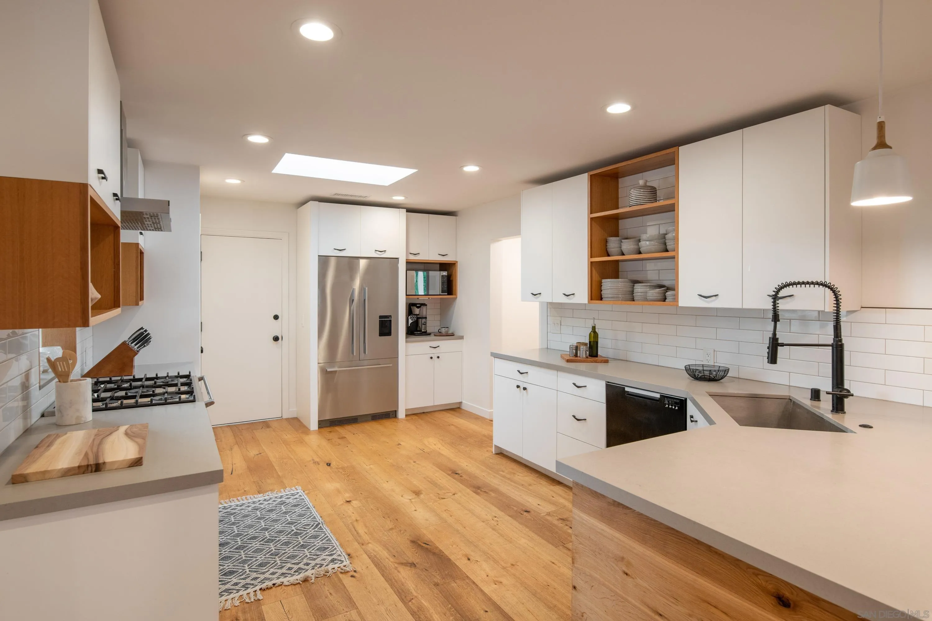 6529 Manana Place La Jolla, CA 92037 - Photo 14 of 36 a large kitchen with stainless steel appliances lots of counter top space and cabinets
